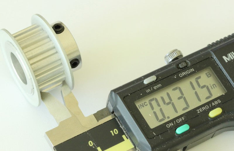 XL 15 teeth drive pulley 1/2" bore .2" pitch shown with caliper. Measurement reads .4315 inches. 